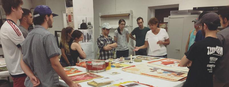 Professor Donna Oliver shows Soviet era posters and materials to students in the Wright Museum.